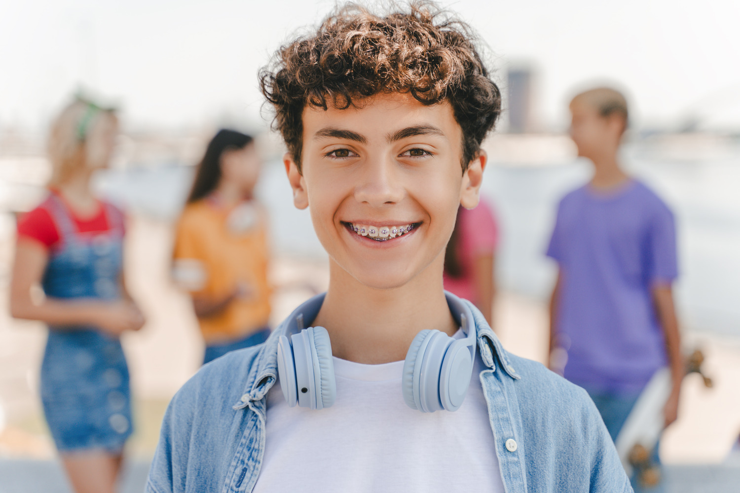 Boy smiling with braces as part of his early orthodontic treatment in Timnath